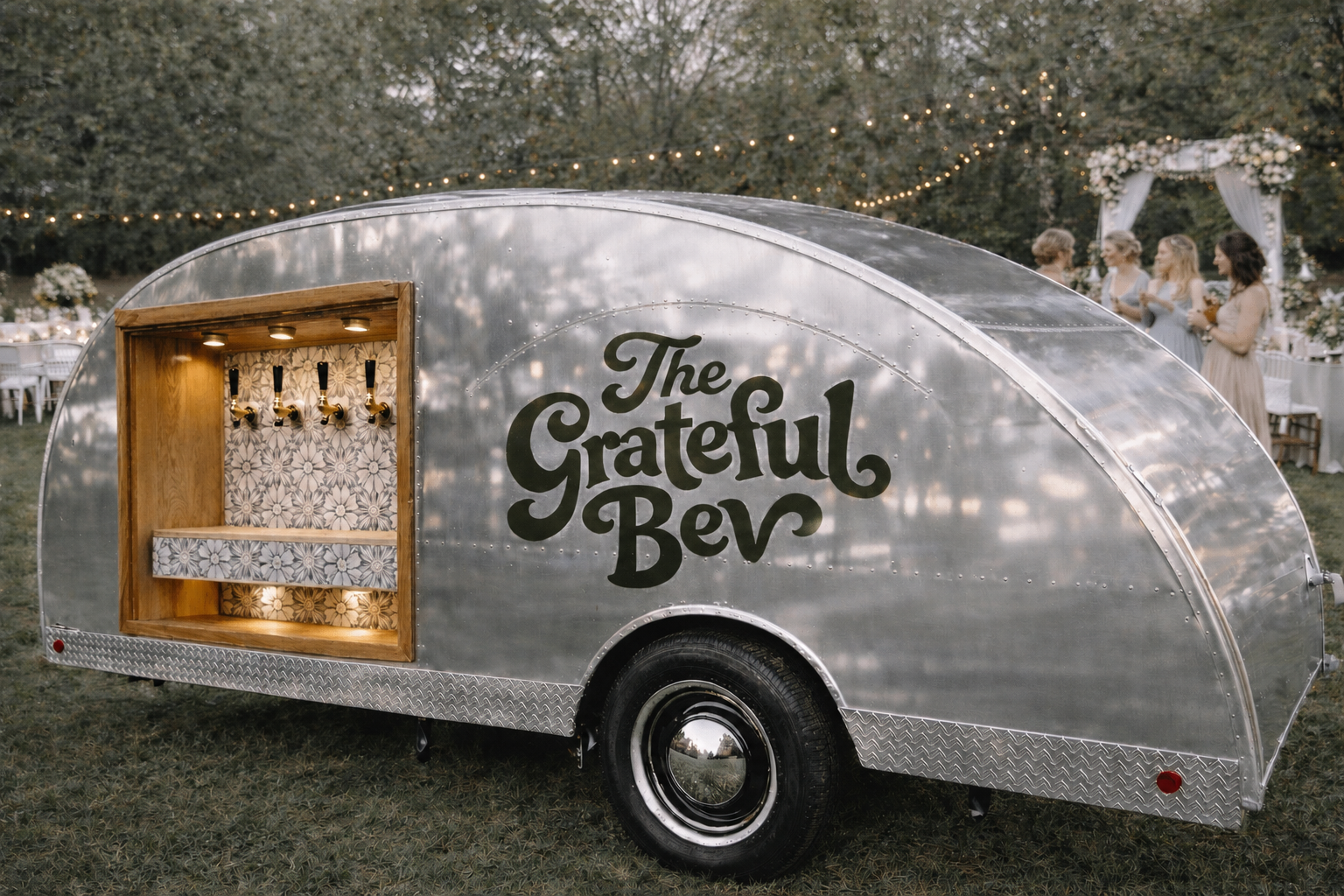 The Grateful Bev vintage mobile beverage trailer at an outdoor wedding